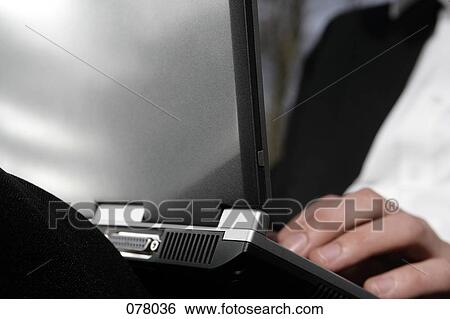 A businessman typing on a laptop computer View Large Photo Image Stock Photograph - A businessman typing on a laptop computer. Fotosearch