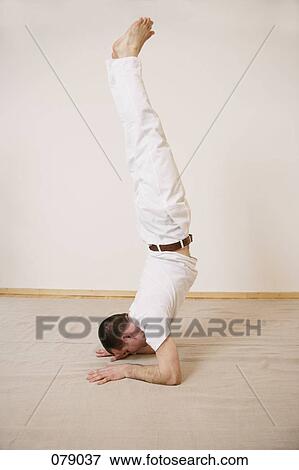 A man in a handstand View Large Photo Image Stock Photo - A man in a handstand. Fotosearch