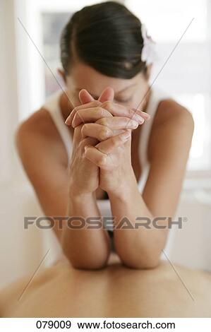 A massage therapist kneading a person's back with her elbows View Large Photo Image Stock Photo - A massage therapist kneading a person's back with her elbows. Fotosearch
