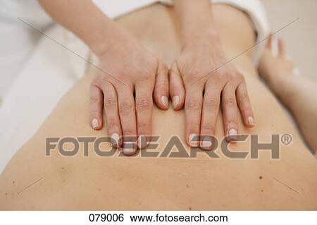 A massage therapist massaging a back View Large Photo Image Stock Photograph - A massage therapist massaging a back . Fotosearch