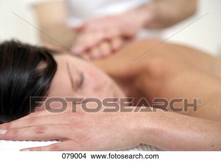 A massage therapist massaging a woman's back View Large Photo Image Picture - A massage therapist massaging a woman's back. Fotosearch