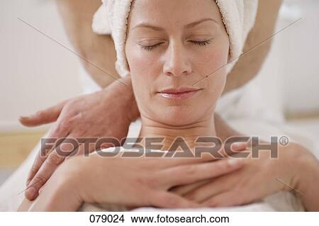 A massage therapist massaging a woman's neck View Large Photo Image Picture - A massage therapist massaging a woman's neck. Fotosearch