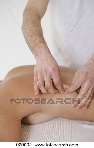 A massage therapist massaging a woman's back View Large Photo Image Stock Image - A massage therapist massaging a woman's back. Fotosearch