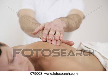 A massage therapist massaging a woman's back View Large Photo Image Stock Image - A massage therapist massaging a woman's back. Fotosearch