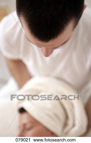 A massage therapist massaging a woman's neck View Large Photo Image Stock Image - A massage therapist massaging a woman's neck. Fotosearch