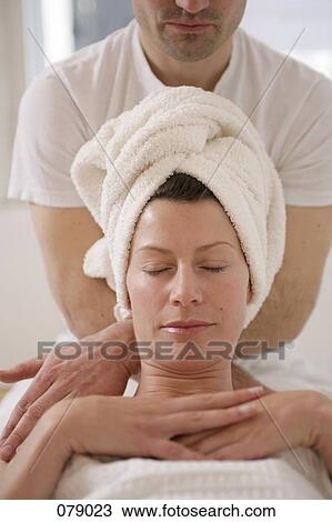 A massage therapist massaging a woman's shoulders View Large Photo Image Stock Image - A massage therapist massaging a woman's shoulders. Fotosearch
