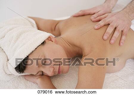 A massage therapist massaging a woman's back View Large Photo Image Stock Photograph - A massage therapist massaging a woman's back. Fotosearch
