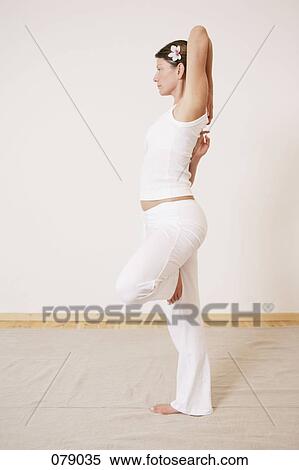 A woman in a yoga pose View Large Photo Image Stock Photography - A woman in a yoga pose. Fotosearch