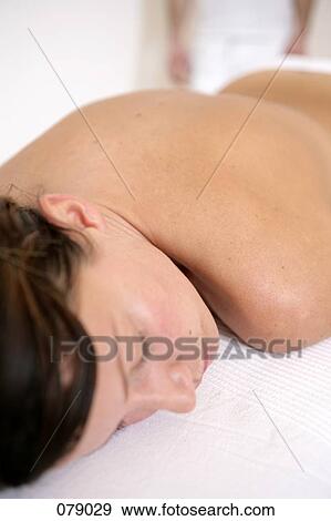 A woman lying on a massage table View Large Photo Image Stock Photo - A woman lying on a massage table. Fotosearch