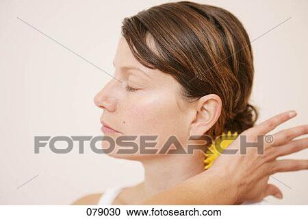 A woman massaging her neck with a massage ball View Large Photo Image Stock Image - A woman massaging her neck with a massage ball. Fotosearch
