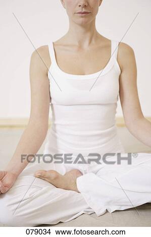 A woman sitting cross-legged View Large Photo Image Picture - A woman sitting cross-legged. Fotosearch