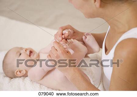 An adult playing with a baby's hands and feet View Large Photo Image Stock Image - An adult playing with a baby's hands and feet. Fotosearch