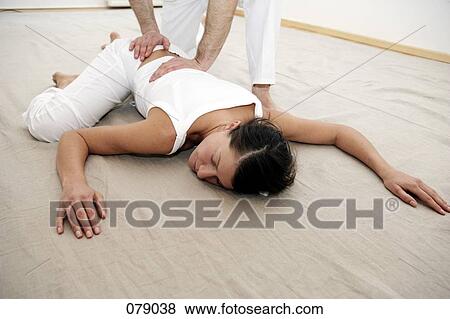 Stock Photo - Two people practicing shiatsu. Fotosearch