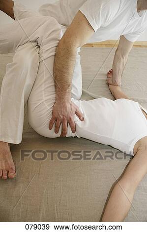 Two people practicing shiatsu View Large Photo Image Stock Photo - Two people practicing shiatsu. Fotosearch