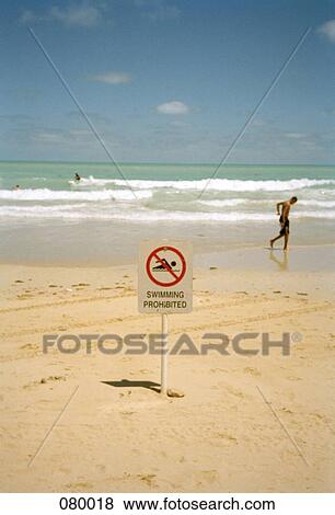 Stock Photo - A swimming prohibited sign on a beach, Australia. Fotosearch