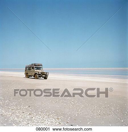 Stock Image - An off-road vehicle in the desert, Australia . Fotosearch
