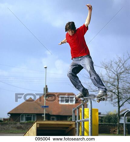 Man on skateboard balancing on railing View Large Photo Image Picture - Man on skateboard balancing on railing. Fotosearch
