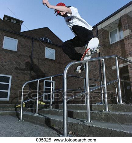 Man on skateboard balancing on railing View Large Photo Image Stock Photography - Man on skateboard balancing on railing . Fotosearch