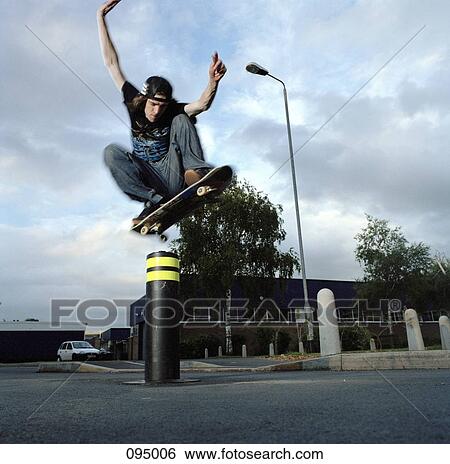 Man on skateboard jumping in air View Large Photo Image Stock Photograph - Man on skateboard jumping in air. Fotosearch