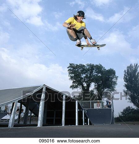 Man on skateboard jumping, mid-air View Large Photo Image Stock Photograph - Man on skateboard jumping, mid-air. Fotosearch