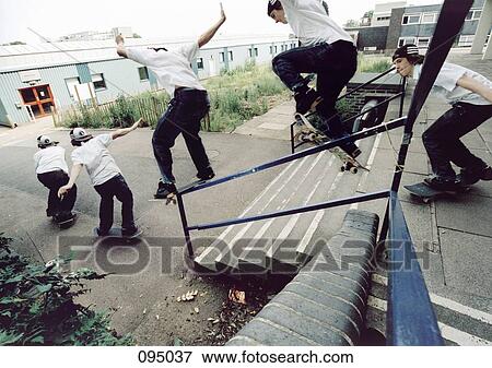 Man on skateboard jumping on and off railing View Large Photo Image Stock Photo - Man on skateboard jumping on and off railing. Fotosearch