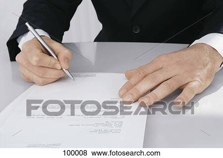 Stock Photo - Businessman holding a pen . Fotosearch