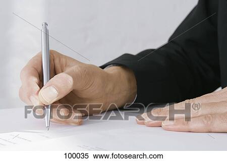 Businessman holding a pen View Large Photo Image Stock Photography - Businessman holding a pen . Fotosearch
