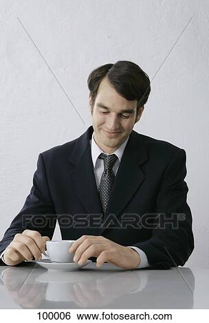 Businessman sitting with coffee cup View Large Photo Image Stock Photograph - Businessman sitting with coffee cup. Fotosearch