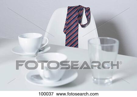 Necktie hanging over chair View Large Photo Image Stock Photo - Necktie hanging over chair . Fotosearch