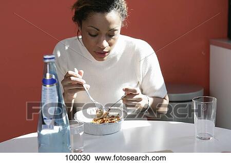 Woman eating take-away pasta View Large Photo Image Stock Image - Woman eating take-away pasta. Fotosearch