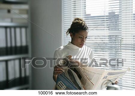Woman reading financial newspaper View Large Photo Image Stock Photograph - Woman reading financial newspaper. Fotosearch