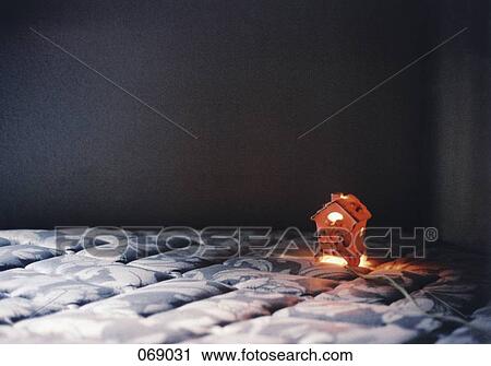 A ceramic house on a bed View Large Photo Image Stock Image - A ceramic house on a bed. Fotosearch