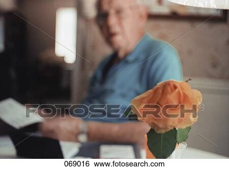 A senior adult man holding a paper View Large Photo Image Stock Photograph - A senior adult man holding a paper. Fotosearch