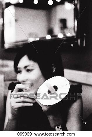 A woman holding a CD ROM View Large Photo Image Stock Photo - A woman holding a CD ROM. Fotosearch