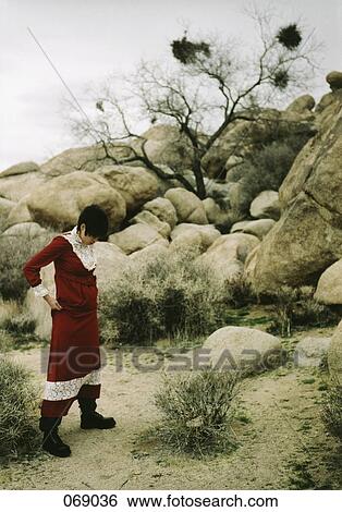 A woman wearing a dress in the desert View Large Photo Image Stock Photograph - A woman wearing a dress in the desert. Fotosearch