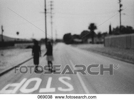 Stock Photo - Two people standing on a road. Fotosearch