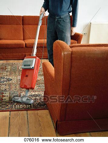 A person vacuuming a rug View Large Photo Image Stock Photograph - A person vacuuming a rug. Fotosearch