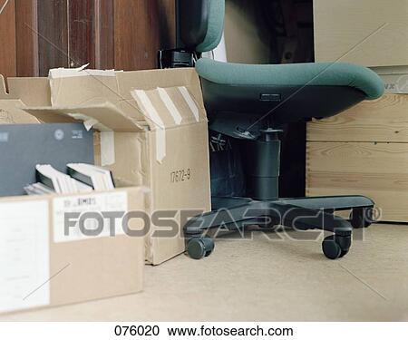 Boxes and a chair in a room View Large Photo Image Stock Image - Boxes and a chair in a room. Fotosearch