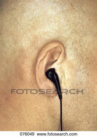 Close-up of man's ear with earphone View Large Photo Image Stock Photo - Close-up of man's ear with earphone . Fotosearch