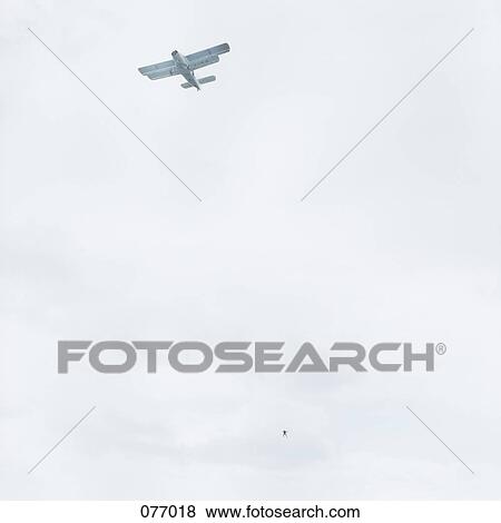 Stock Photo - An airplane and skydiver. Fotosearch