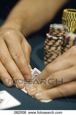 A man looking at his cards in a casino, Las Vegas, Nevada, USA View Large Photo Image Stock Photo - A man looking at his cards in a casino, Las Vegas, Nevada, USA. Fotosearch