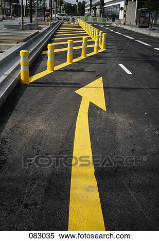 Stock Photography - Yellow arrow on city street. Fotosearch
