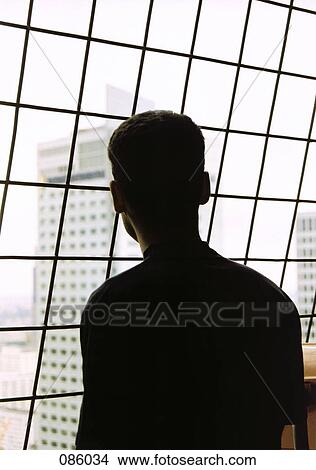 Man looking out of window View Large Photo Image Picture - Man looking out of window. Fotosearch