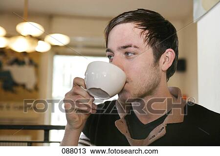 A man drinking a cup of coffee View Large Photo Image Stock Image - A man drinking a cup of coffee. Fotosearch