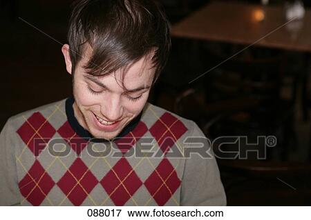 Stock Photo - A man smiling in a cafe. Fotosearch