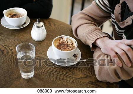 Close-up of two people sitting in a cafe View Large Photo Image Stock Photo - Close-up of two people sitting in a cafe . Fotosearch
