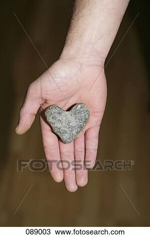 Heart shaped stone in man's hand View Large Photo Image Stock Image - Heart shaped stone in man's hand. Fotosearch