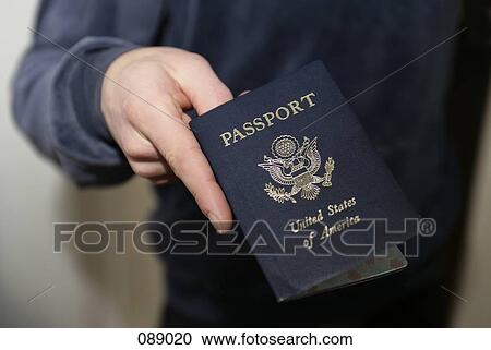 Man holding American passport View Large Photo Image Stock Image - Man holding American passport. Fotosearch
