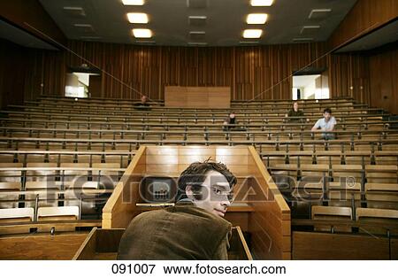 A professor looking over his shoulder in a lecture hall View Large Photo Image Stock Photo - A professor looking over his shoulder in a lecture hall. Fotosearch