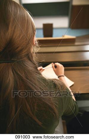 Woman sitting in lecture hall View Large Photo Image Stock Image - Woman sitting in lecture hall . Fotosearch